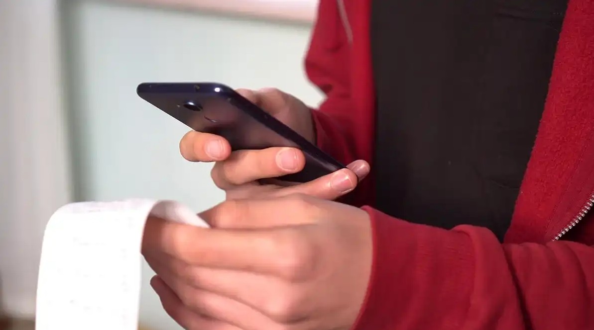 Someone checking receipt with coupon app