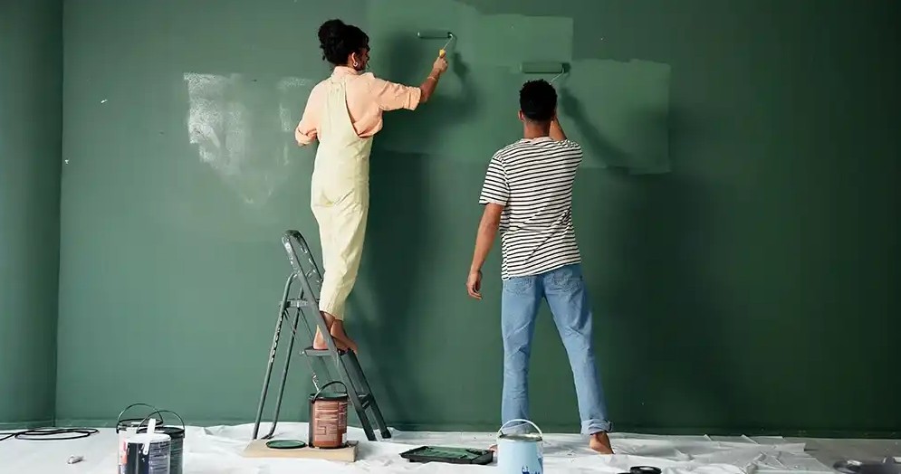 diy painting A couple painting their house