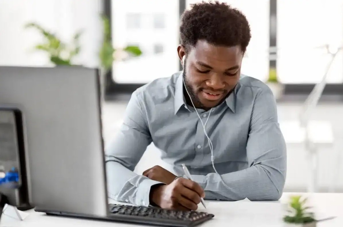 Man listening to finance podcast while working