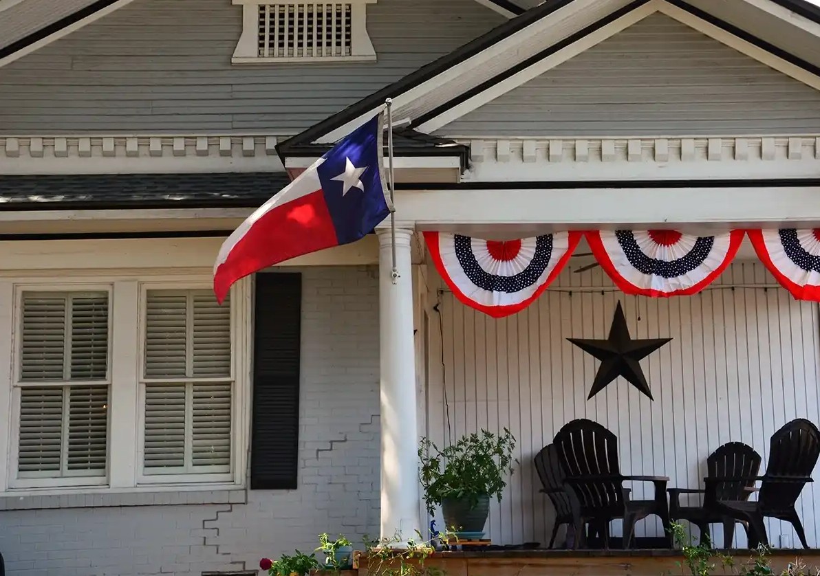Texas flying infront of house