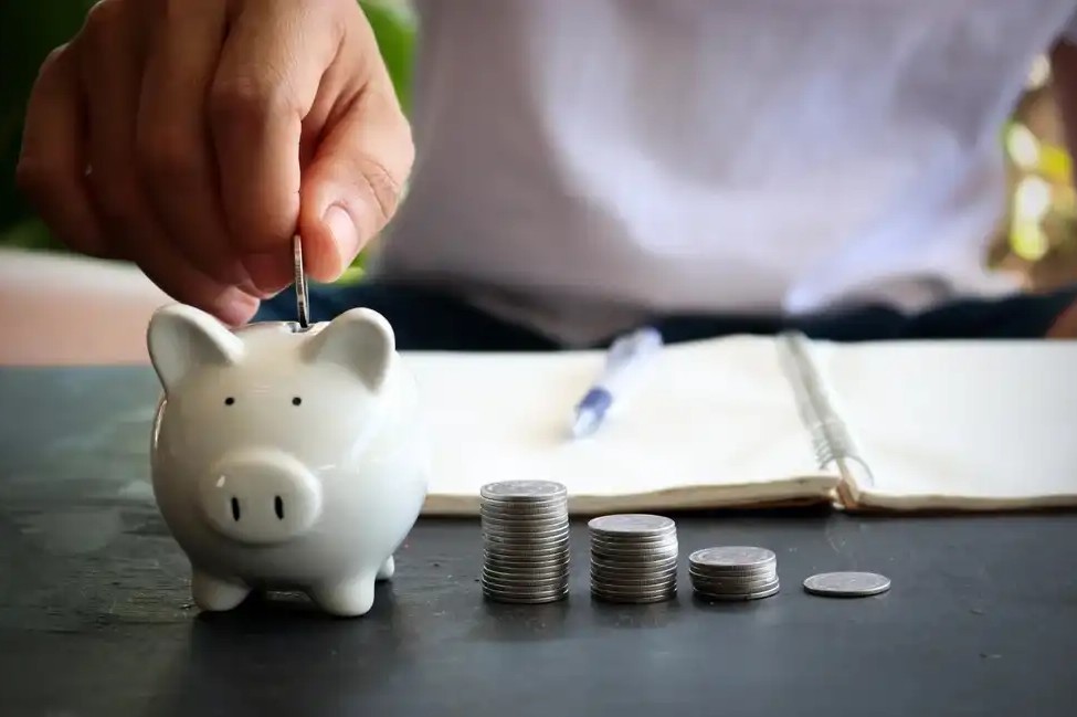 A man saving money in a piggy bank