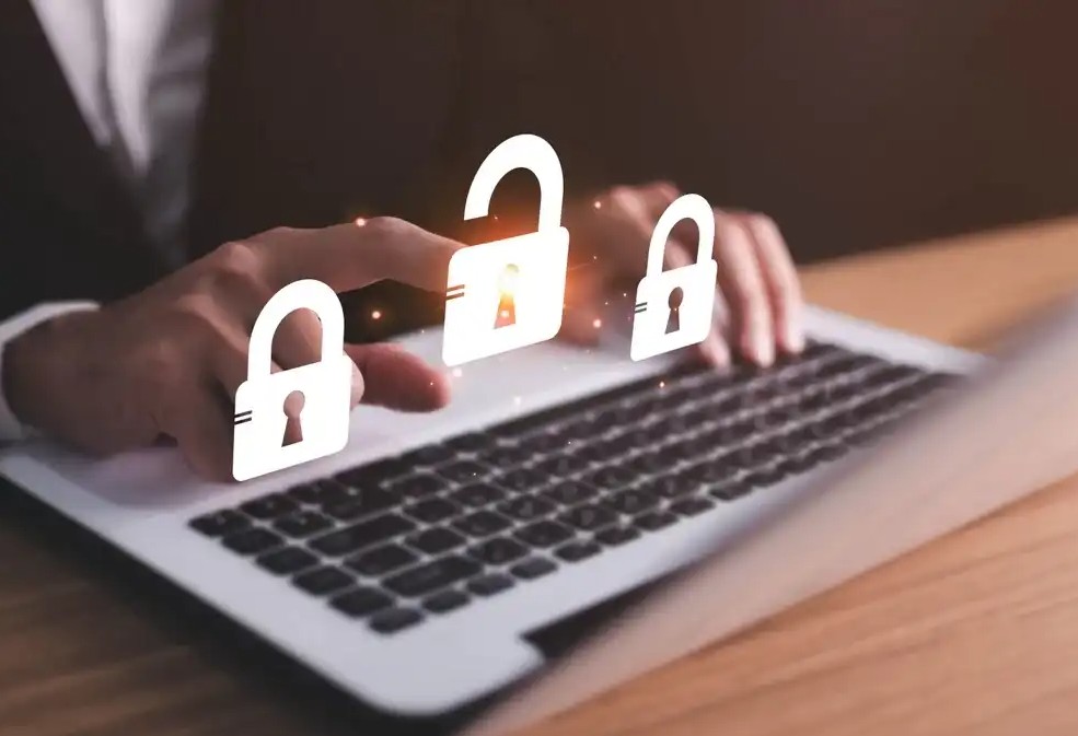 Locks hovering over someone typing on a laptop