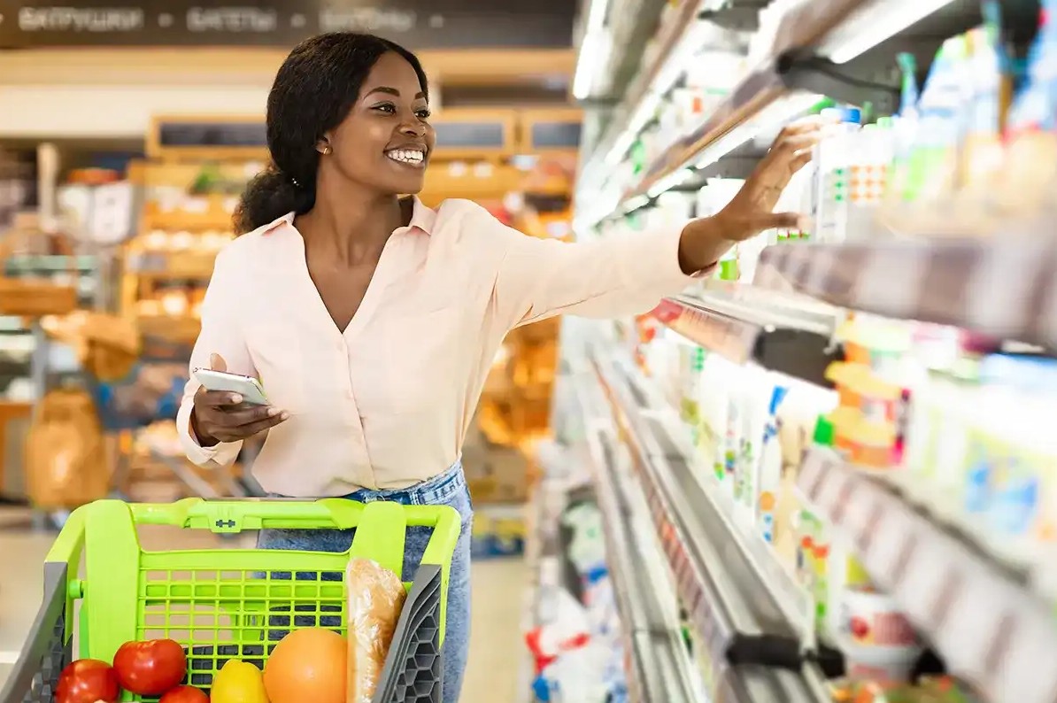 Woman using coupon app to save at store